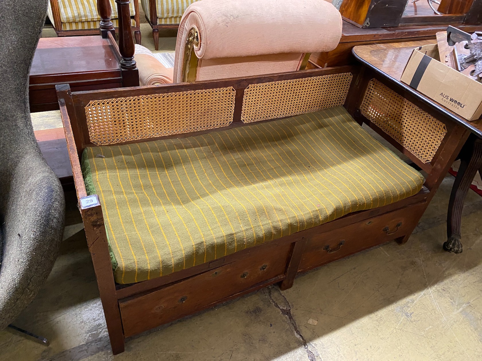 A provincial rustic oak bergère caned two drawer low bench seat, length 136cm, depth 61cm, height 67cm